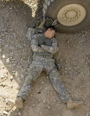 A U.S. soldier rests before leaving for a security support mission ...
